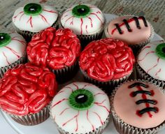 there are many cupcakes decorated to look like creepy eyes and blood on them