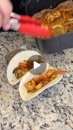 a person cutting up some food on top of a counter next to a pan and spatula