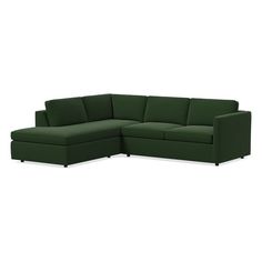 a green sectional couch sitting on top of a white floor