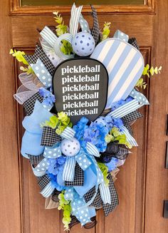 a wreath that says pickleball, pickleball and baseball is on the front door