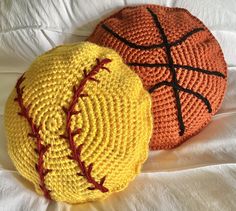 two crocheted balls sitting on top of a bed