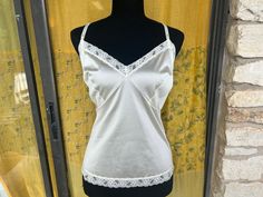 beautiful vintage 70's camisole featuring floral patterned lace along the collar and adjustable spaghetti straps.  Condition: great, no staining or tears. Tag: JC Penney, Size 40 Measurements Bust: 44" Waist: 19" Cheap Vintage Camisole For Spring, Lace Camisole, Vintage 70s, Floral Lace, Favorite Outfit, Spaghetti Strap, 1970s, Spaghetti, Bathing Beauties