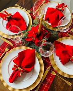 the table is set with red napkins and gold place settings for christmas dinner guests