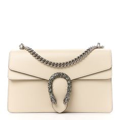 This is an authentic GUCCI Textured Calfskin Crystal Small Dionysus Shoulder Bag in Mystic White. This stylish bag is crafted oftextured calfskin leather in white. This shoulder bag features an aged silver chain shoulder strap, and a textured horseshoe closure with lion heads at the end. This opens to a beige fabricinterior with a central zipper pocket. Luxury Cream Textured Leather Shoulder Bag, Gucci Luxury Leather Shoulder Bag, Elegant Gucci Soft Leather Bags, Gucci Rectangular Bag With Leather Lining, Gucci Timeless Crossbody Shoulder Bag, Timeless Gucci Crossbody Shoulder Bag, Gucci Luxury Soft Leather Shoulder Bag, Luxury Gucci Shoulder Bag In Soft Leather, Gucci Soft Leather Bag For Formal Occasions