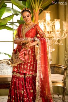 Endearing Pakistani Gharara Online For Wedding Party is chic and sophisticatedly designed in old techniques embroidered in dabka, tilla, zari thread work. Wedding Pakistani sharara suit is itself a charm with its intricate emblazoned work. The combination of red and golden working on the complete dress is completely breathtaking. Compliment the look with gajra on hair with intricate jewelry and be ready to flaunt beauty at your wedding festive. Shirt: Beautiful intricate designed shirt with ghar Raw Silk Sharara With Dabka Work For Reception, Wedding Sharara With Dabka Work And Traditional Drape, Gold Sharara With Dabka For Reception, Wedding Sharara With Dabka Work, Chinon Sharara With Dabka For Reception, Intricately Embroidered Raw Silk Sharara For Wedding, Intricate Embroidered Raw Silk Sharara For Wedding, Kundan Sharara For Reception Eid Festival, Elegant Naqshi Sharara For Festivals