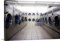 a row of washers and dryers in a laundry room