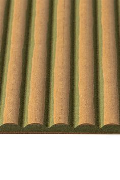 a close up view of the top of a corrugated roof with green and brown stripes