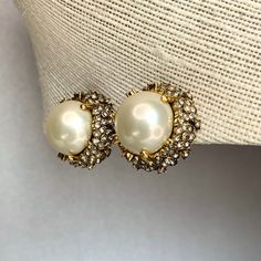 "Vintage Ciner White Cabochons Earrings, Gold Tone Clear Rhinestones Flowers Chunky Pearl Clip on Earrings, Signed Jewelry, Gift for Her. Era: After 1949. Designer Signed: Ciner. Measurements: - Length: 1 1/8\" inches - Width: 1 1/8\" inches - High: 3/4\" inch Details: -Metal Color: Gold - Embellishments: Gold Tone Plating, White Pearl Cabochons , Clear Rhinestones Flowers around a Dome Shaped Earrings. - Closure: Clip On. Here are more Vintage Jewelry items for your viewing pleasure: https://et Elegant Clip-on Cluster Earrings For Evening, Elegant Evening Cluster Clip-on Earrings, Classic Rhinestone Earrings For Anniversary, Classic Anniversary Earrings With Rhinestones, Pearl Earrings With Diamond Accents For Evening, Elegant Round Crystal Earrings With Rhinestones, Elegant Round Clip-on Crystal Earrings, Gold Pearl Earrings With Rhinestones, Round Crystal Pearl Earrings For Formal Events