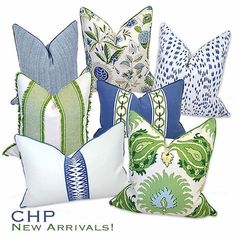 four pillows with different colors and patterns on them, one is blue, the other is green