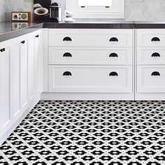 a black and white tiled floor in a kitchen