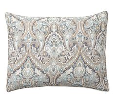 a blue and white pillow with an ornate design on the front, along with a black border