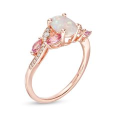 Lithe and lovely, this fashion ring reflects her exquisite taste. Crafted in sterling silver with 14K rose gold plate, this beautiful design features an 8.0 x 6.0mm oval-shaped lab-created iridescent opal cabochon. A trio of lab-created white sapphires in a marquise-shaped frame punctuates each side of the curved created sapphire-lined shank while pairs of leaf-like 4 x 2.0mm marquise-cut lab-created bright pink sapphires add sweet color to the look. Buffed to a brilliant luster, this style elevates any attire. Custom-made to fit your ring size. Sterling silver rings cannot be resized after purchase. Exquisite 14k Rose Gold Ring, 14k Rose Gold Ring With Center Stone, Elegant Pink Cluster Ring In 14k Gold, 14k Rose Gold Rings With Accent Stones, Exquisite Rose Gold Rings With Accent Stones, Elegant Pink Opal Ring In Sterling Silver, Elegant Pink Opal Sterling Silver Ring, Rose Gold Hallmarked Jewelry For Promise Ring, Elegant Hallmarked Pink Diamond Ring