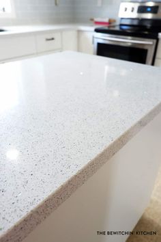 a white counter top in a kitchen next to an oven