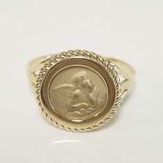 "Thanks for shopping our vintage estate store. We tend to sell well below wholesale and truly hope you enjoy all of our items. Many of the items are one of a kind, so please enjoy scrolling through the pictures and hopefully something will catch your eye. Black/red spots are from reflections. Nice 14k yellow gold heaven's angel twisted rope coin ring. Size: 7 Setting: 1/2\" 13mm Band width: 1.5mm Weight: 3.14 grams Beautiful ring one that you will love. Marked 14k." Heirloom Gold Rings For Memorial, Heirloom Style Hallmarked Engraved Ring For Memorial, 14k Gold Signet Ring With Polished Finish, Heirloom Yellow Gold Signet Ring For Commemoration, Fine Jewelry With Certificate Of Authenticity, Oval Shape, Oval Jewelry With Certificate For Anniversary, Heirloom Anniversary Rings With Certificate Of Authenticity, Collectible Yellow Gold Engraved Ring With Hallmarks, Antique Gold Signet Ring For Commemoration