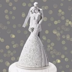 a wedding cake topper with a bride and groom on it