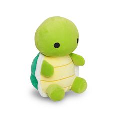 a small stuffed turtle sitting on top of a white surface