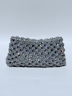 THE CLUTCH Our Crystal Rhinestone Clutch is handwoven in thousands of beautiful pavé crystal rhinestones for maximum sparkle.  An amazing statement piece.   Once in the sun or lights, stunning gives way to EPIC sparkles! Beautiful for a wedding be it for the bride, bridesmaids or guests.  DETAILS: *Dimensions (approximate, each are hand made): - 9 inches wide - 5 inches tall *Interior magnetic clasp. Contact us for specific measurements and custom options. All handbags and clutches are handmade Statement Purse, Braided Bag, Handwoven Bag, Knot Bag, Rhinestone Clutch, Crystal Clutch, Wedding Bag, Magnetic Clasp, Clutch Handbag