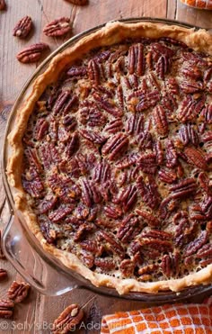 a pecan pie is sitting on a wooden table