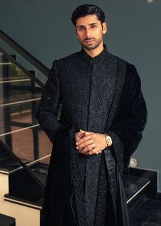 Gender: Men Category: Clothing Outfit Type: Eastern Sub-Category: Sherwani Color Type: Black Fabric: Jacquard Number of Pieces: 1 Piece - Outerwear Product Type: Bride/Groom Wear Season: All Season Work Technique: Embellished Additional Description: This Sherwani is truly exclusive, featuring intricate handmade work on the entire front. Crafted in traditional black, it's specially designed for event wear, ensuring you an unparalleled sense of luxury and sophistication. The fabric is intricately embroidered jacquard, adding to its elegance and charm. Experience the epitome of exclusivity, making every moment memorable. Disclaimer: Actual product color may vary slightly from the image. High Class Fashion, Sherwani For Men Wedding, Prince Coat, Wedding Outfits For Groom, Black Outfit Men, Bride And Groom Outfits