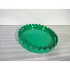 a green plastic plate sitting on top of a table