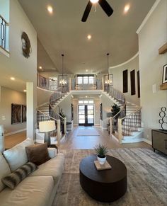 a living room filled with furniture and a spiral staircase