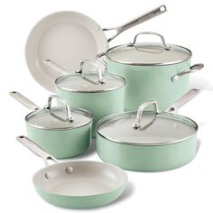 a set of green pots and pans with lids