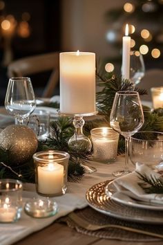 the table is set with candles, plates and silverware