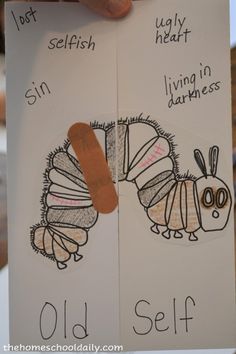 a person holding up two handmade cards with pictures of caterpillars