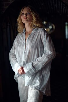 Airy and unrestrained, this relaxed fit cotton gauze blouse stands out with classic design details–an elegant back pleat, fabric covered buttons, wide cuffs, and a gold hardware detail at the back. Perfect for sipping sarsaparilla on the porch or layering over your chemise for a moonlit ride across the open range. Style with the Ivory Duchess Corset and Lake Stripe Pantalettes to complete the look. Cotton gauze button up shirt Relaxed fit Long sleeves Fabric covered buttons Gold hardware Selkie Summer Workwear Tops With Set-in Sleeves, Summer Cotton Blouse With Set-in Sleeves, Relaxed Fit Shirt For Daywear, Summer Shirt With Button Cuffs For Daywear, Timeless Summer Tops For Daywear, Timeless Tops For Summer Daywear, Timeless Long Sleeve Tops For Daywear, Summer Workwear Blouse With Unlined Sleeves, Relaxed Fit Blouse With Shirttail Hem For Daywear