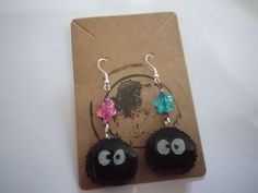 This cute pair inspired by the soot sprites in the movie 'spirited away' by studio ghibli are a fun pair of dangly earrings with star beads.     Contact for this pair with allergen friendly plastic earring hooks  Contact for a pair of custom sprite earrings including clip on options Soot Sprite Craft, Soot Sprite Ceramic, Soot Sprite Necklace, Soot Sprite Earrings, Studio Ghibli Earrings, Soot Sprites, Cute Gifts For Her, Plastic Earrings, Orange Earrings