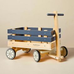 a wooden toy wagon with blue seats and wheels