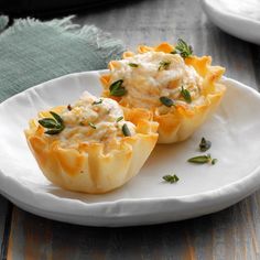 two cups filled with food sitting on top of a white plate