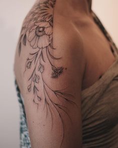 a woman with a flower tattoo on her shoulder