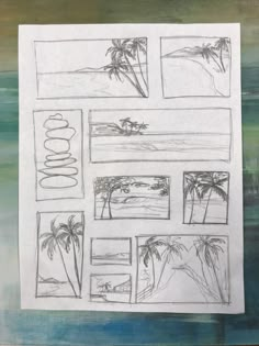 a piece of paper that has been drawn with pencils on it, and some palm trees in the background