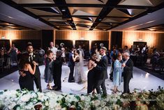 a group of people standing on top of a dance floor in front of a crowd