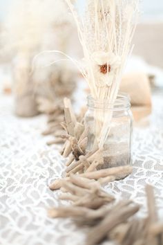 some dried plants are in a jar on a table