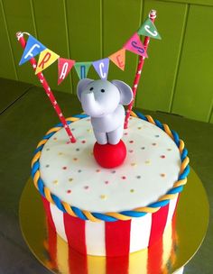 a birthday cake with an elephant on top