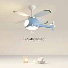 a ceiling fan with clouds floating around it