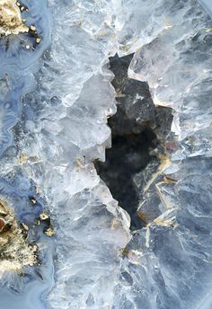 an image of some ice and rocks in the water that is blue with gold flecks