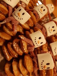 a pile of doughnuts with diced faces on them and bows tied around them