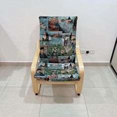 a chair with pictures on it sitting in the middle of a room next to a wall