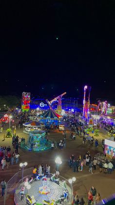 an amusement park at night with many rides