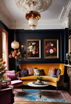 a living room filled with furniture and paintings on the wall