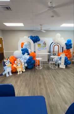 an office decorated with blue, orange and white balloons for children's birthdays