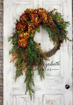 a white door with a wreath on it