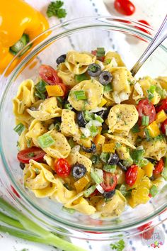 a glass bowl filled with pasta salad