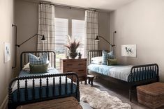 two twin beds in a bedroom with blue and green bedding