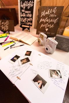 the table is set up with photos and writing on it, along with other items