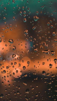 raindrops on the window with blurry buildings in the background