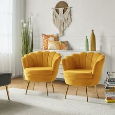 two yellow chairs sitting next to each other in a living room